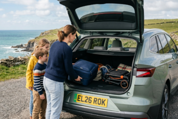 2026 Skoda Elroq electric SUV with family loading luggage into spacious trunk on coastal road